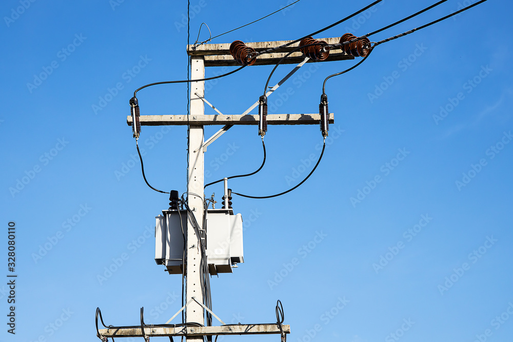 Power supply transformer on electricity pole on blue sky background Power supply transformer on electricity pole on blue sky background