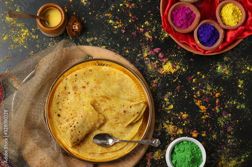 PopuIndian sweet bread known as Puran poli (Gram floor and jaggery stuffed bread), Dahi vada, thandai are well known indian Holi snack. (Holi Concept)