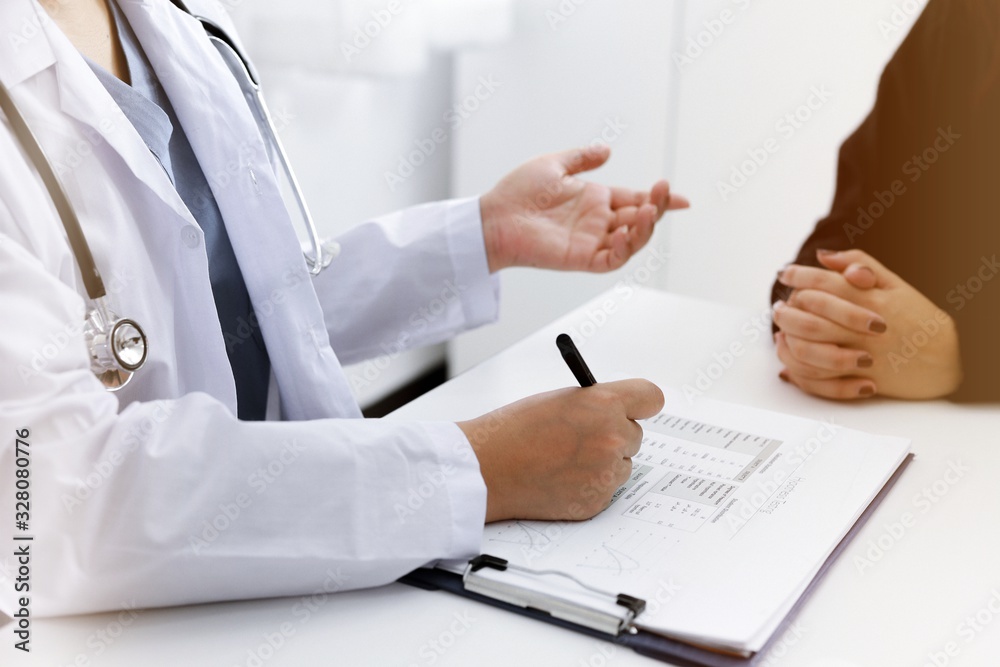 Doctor talking with patient in doctors office Doctor talking with patient in doctors office