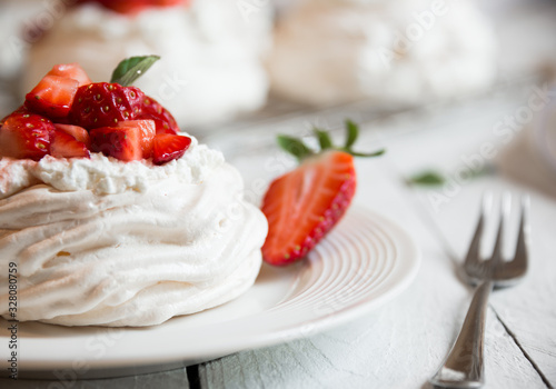 Delicious Pavlova cake with meringue and fresh strawberries