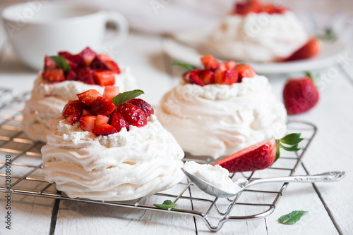 Delicious Pavlova cake with meringue and fresh strawberries photo