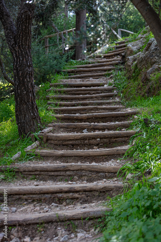 Wooden stairs at Filopappou hill  in Greece drive visitors to the top of it. Adventure  hiking and healthy lifestyle at wild nature background  vertical view.