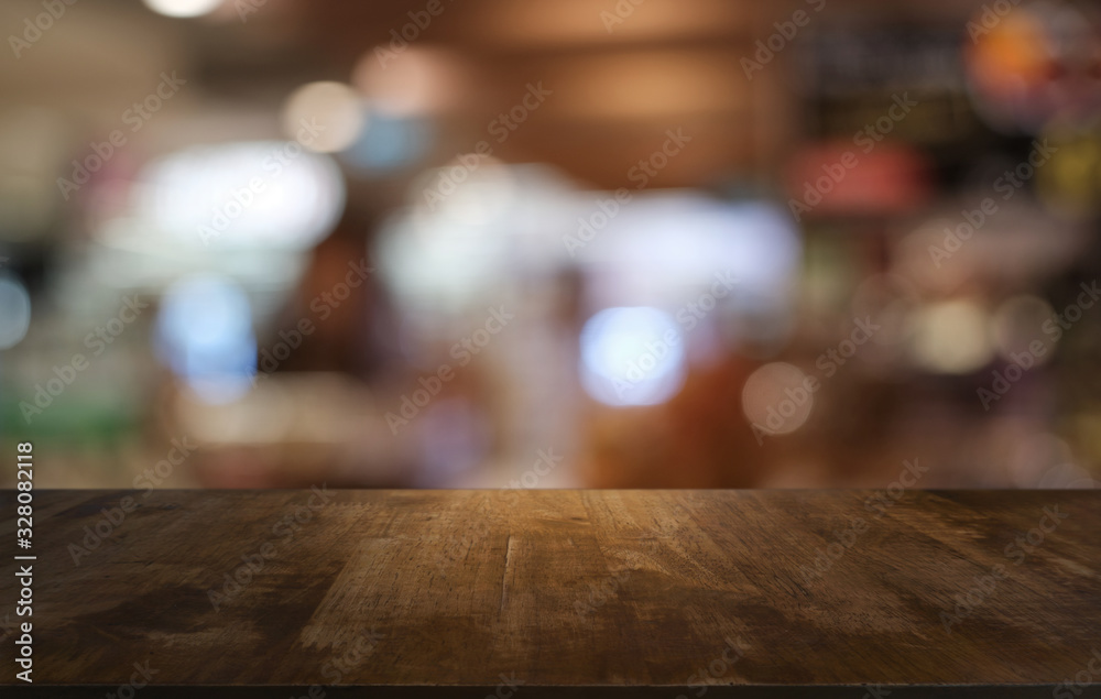 Empty dark wooden table in front of abstract blurred bokeh background of restaurant . can be used for display or montage your products.Mock up for space.