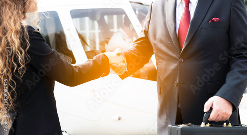 Two business men and woman shaking hand to appreciate each other about aviation business and helicopter platform background, Close up people hands shake business partnership successful outdoors, Deal 