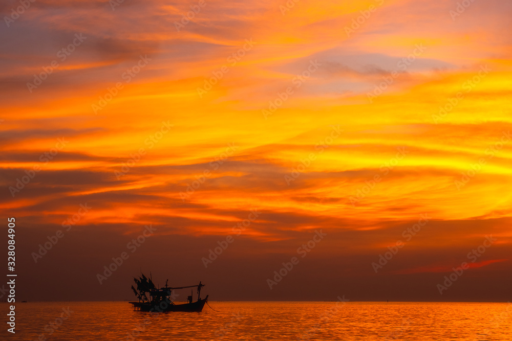 View on silhouettes of wooden pier and two boats and people relaxing and fishing in evening few moments before sunset with sun and clouds reflection sea water in summer Side,Pattaya Thailand