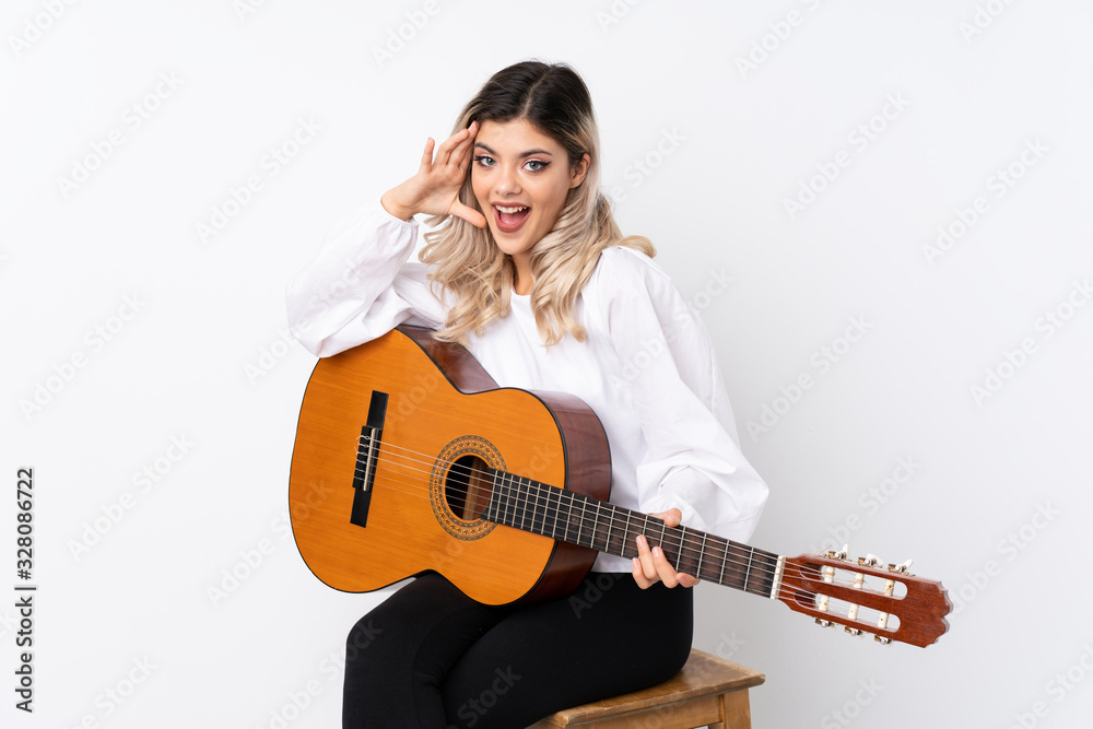 Teenager girl with guitar over isolated white background with surprise and shocked facial expression Teenager girl with guitar over isolated white background with surprise and shocked facial expression