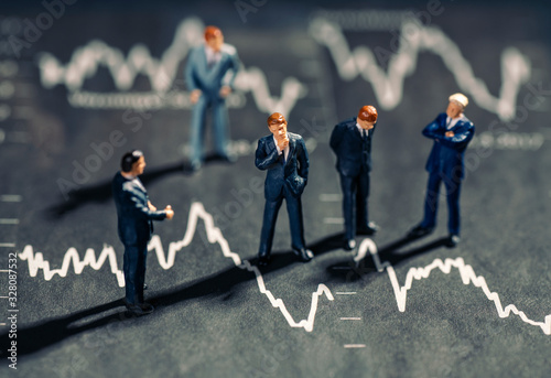 Businessmen and chart with falling stock prices photo