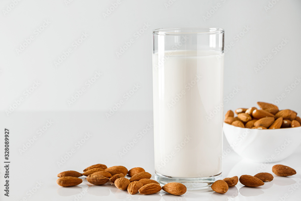 Super Food - A glass of almond milk for a healthy diet. Trending food, vertical photo. Place for your text. Super Food - A glass of almond milk for a healthy diet. Trending food, vertical photo. Place for your text.