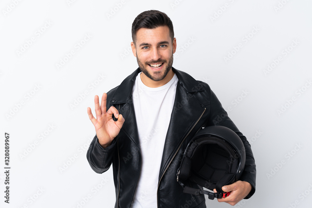 Fototapeta premium Man with a motorcycle helmet showing an ok sign with fingers
