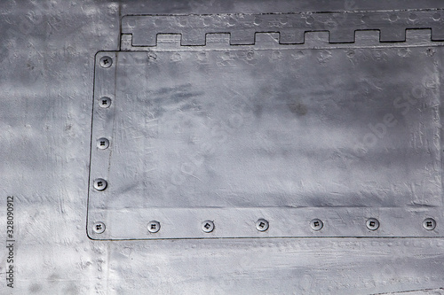Aircraft skin close up. Rivets on gray metal.