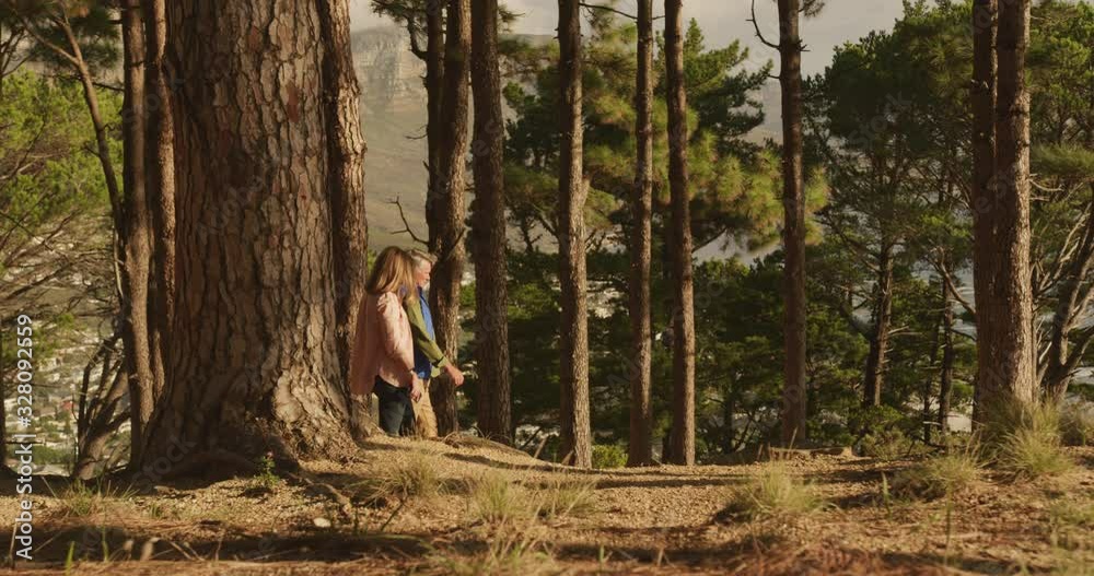 Active senior couple walking in forest Active senior couple walking in forest