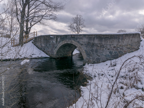 arched bridge over a fast flowing river