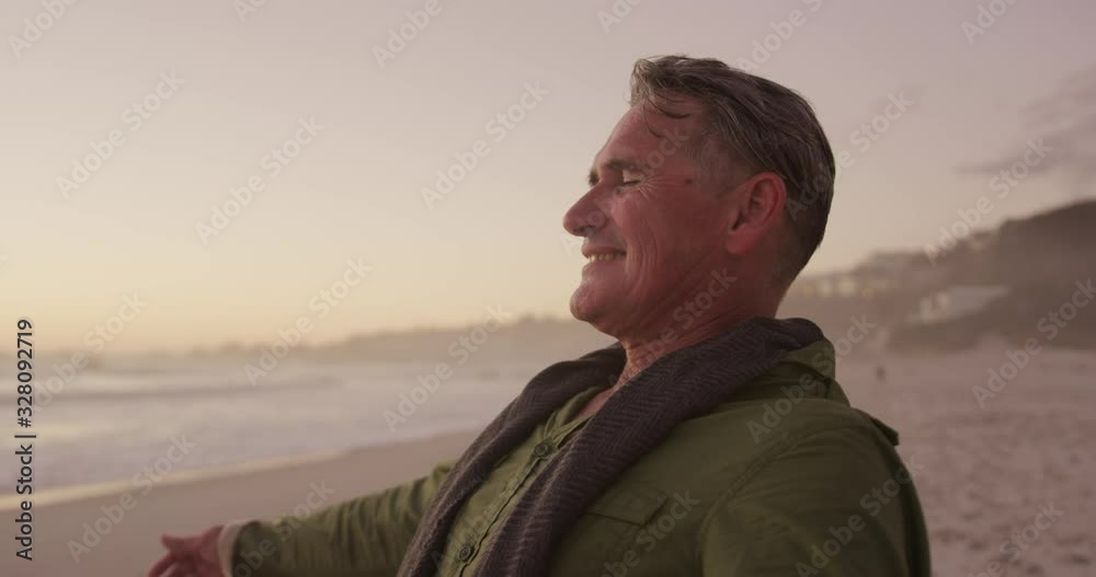 Active senior standing on beach Active senior standing on beach