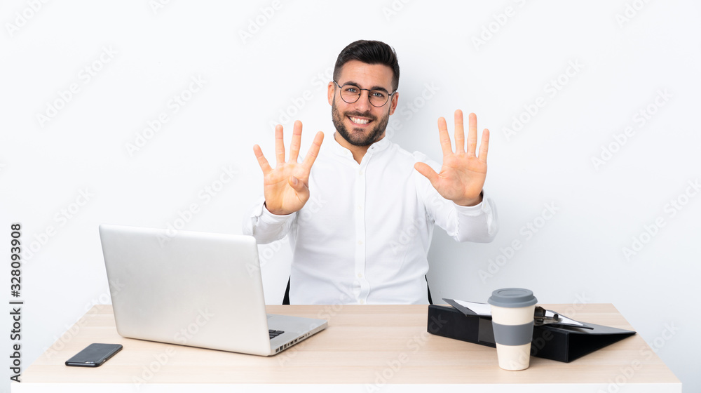 Young businessman in a workplace counting nine with fingers Young businessman in a workplace counting nine with fingers