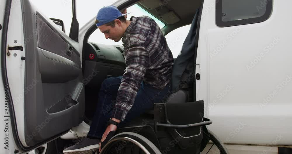 Disabled man with wheelchair getting out his car