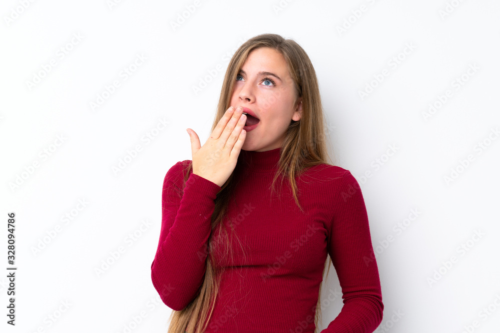 Teenager blonde girl over isolated white background yawning and covering wide open mouth with hand Teenager blonde girl over isolated white background yawning and covering wide open mouth with hand