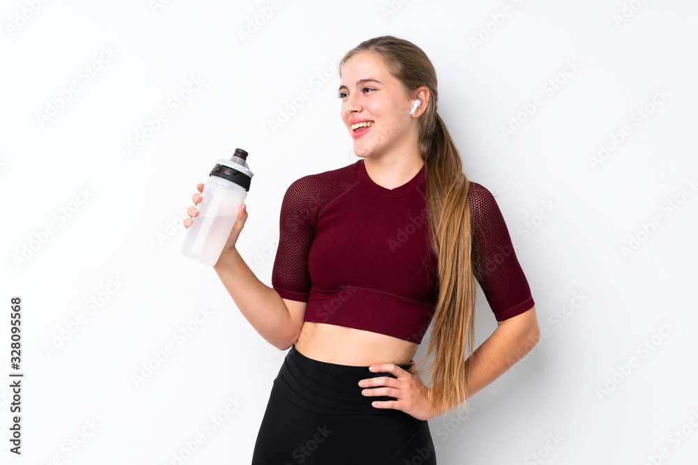 Sport teenager girl over isolated white background with sports water bottle
