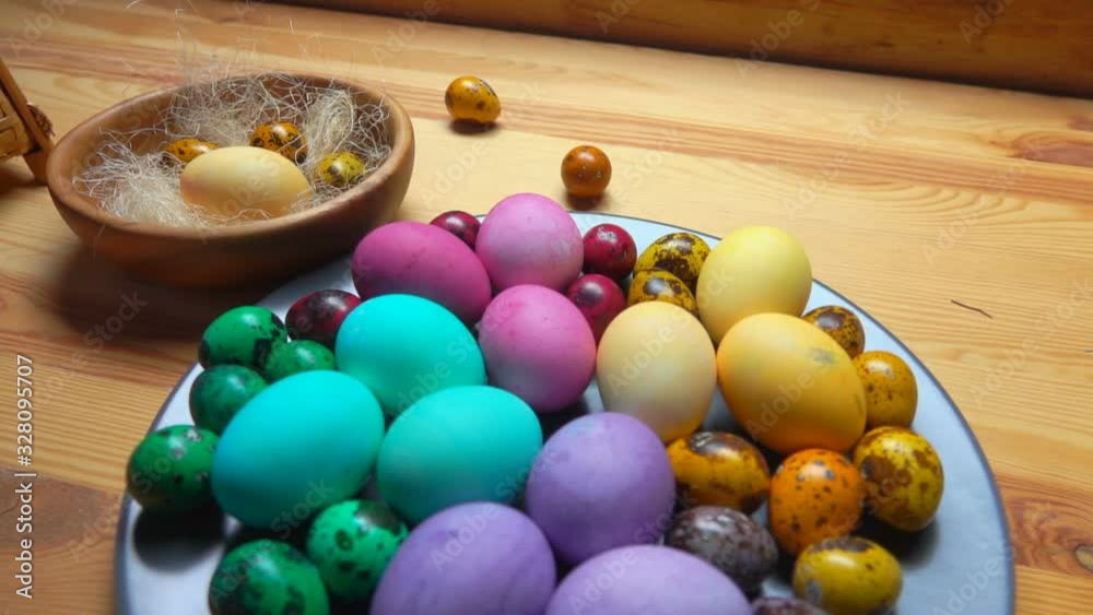 Easter table setting for the festive breakfast: Multi colored Easter eggs on the grey plate on the wooden table Easter table setting for the festive breakfast: Multi colored Easter eggs on the grey plate on the wooden table