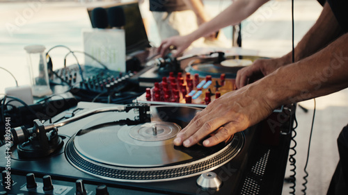 Dj and turntable with record. Summer party