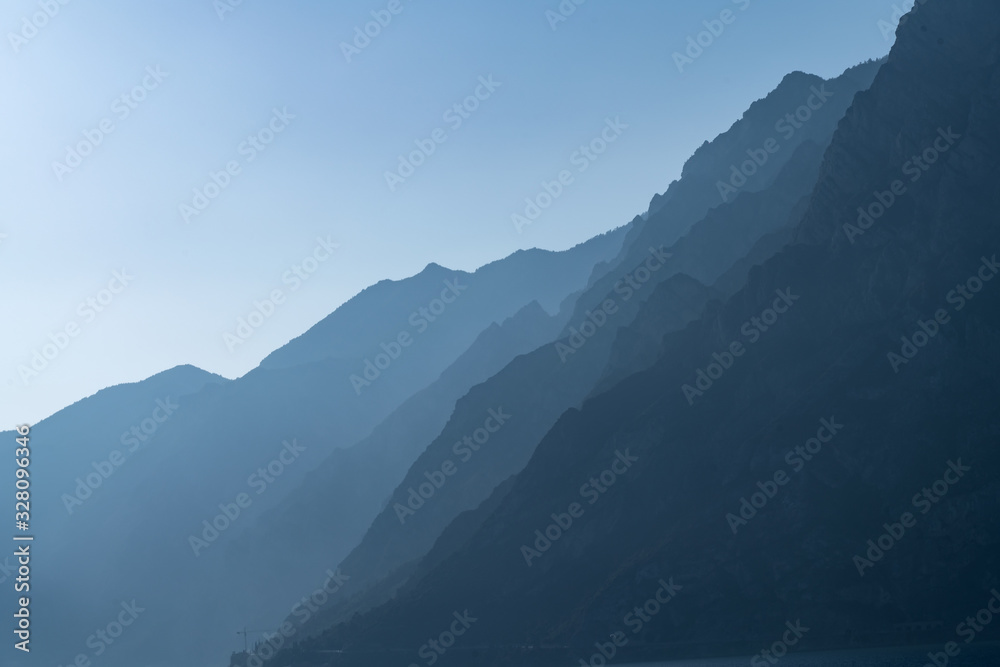 Morning landscape on hills and mountains with humidity in the air and pollution. Lake Garda, Italy