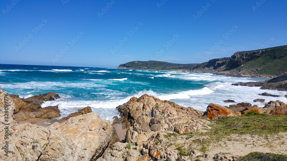 An amazing rocky beach next to a body of water in south africa Plettenberg Bay