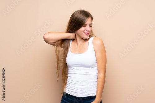 Teenager blonde girl over isolated background with neckache