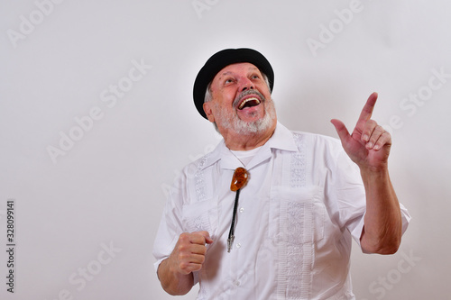 Happy old man smiling and pointing.Elderly gentleman sming and pointing at copy space.Senior man smiling and pointing. photo