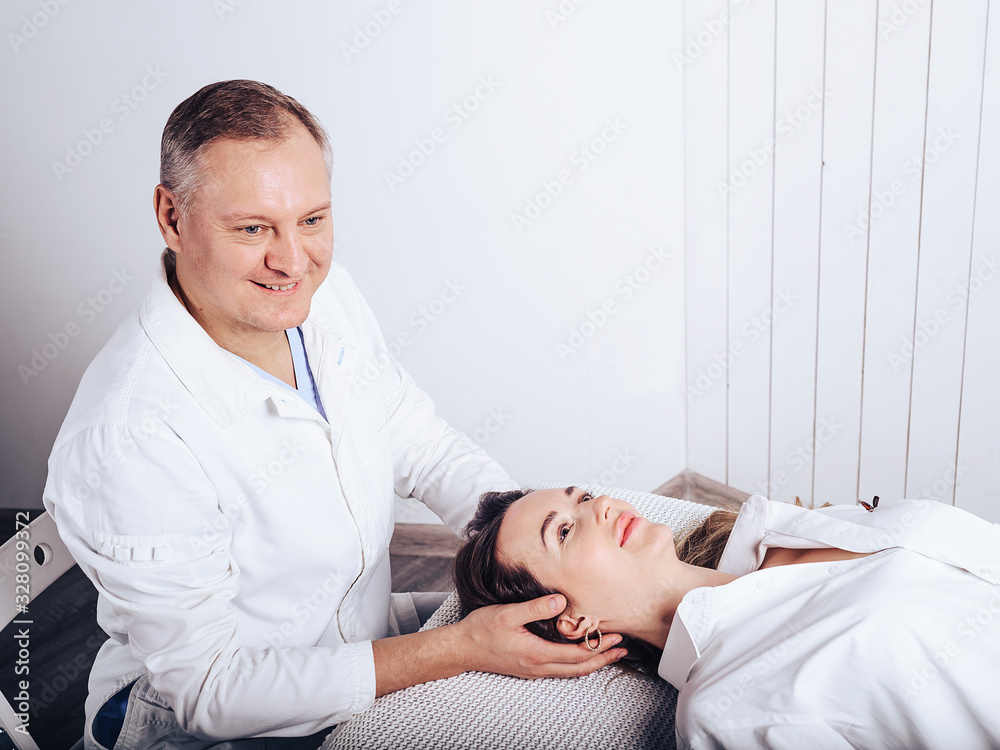 A young girl at the doctor of osteopath , to treat curvature of the spine. A young girl at the doctor of osteopath , to treat curvature of the spine.