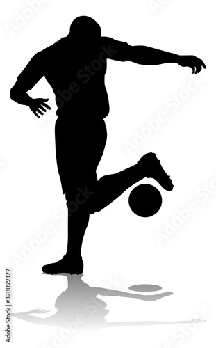 A soccer or football player in silhouette