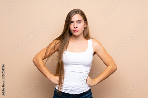 Teenager blonde girl over isolated background angry