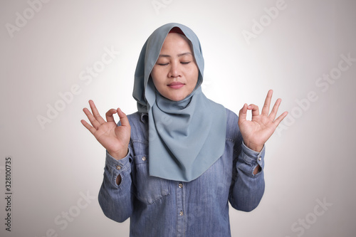 Asian Muslim Woman Doing Relaxing Yoga