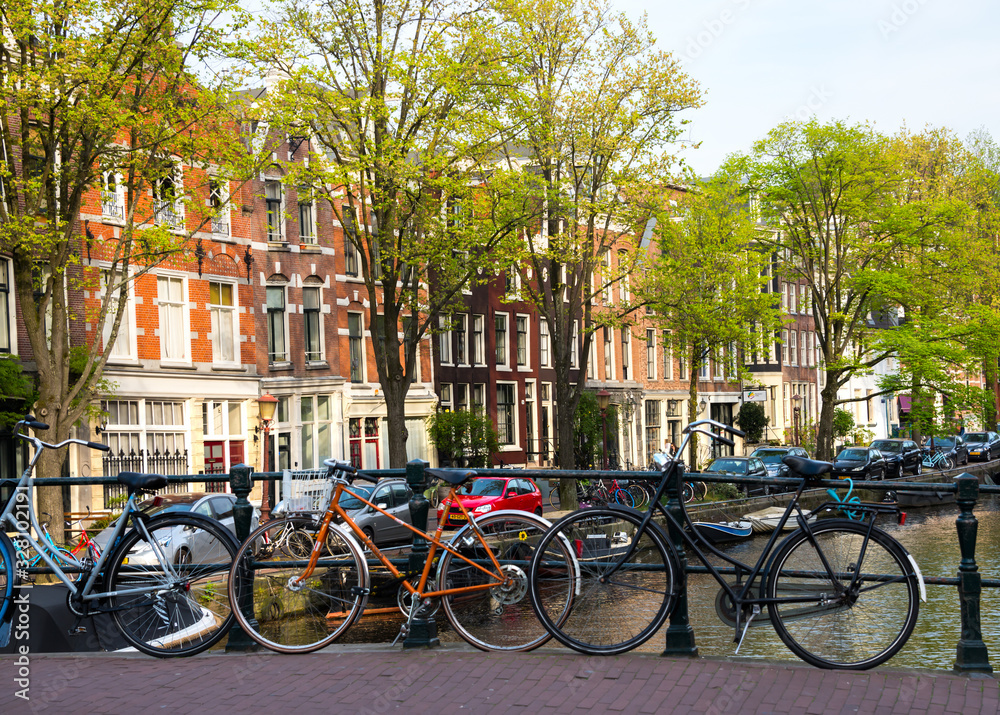 Amsterdam city in Netherlands with bycicles beside a canal