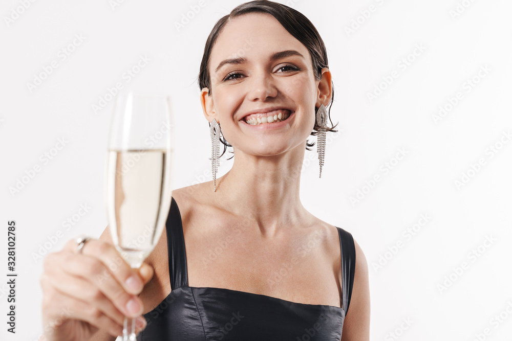 Image of young happy woman smiling and holding glass of champagne Image of young happy woman smiling and holding glass of champagne