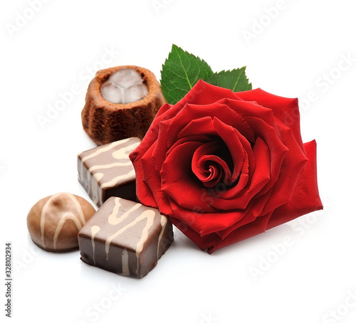 Chocolate candy and red rose flowers . photo