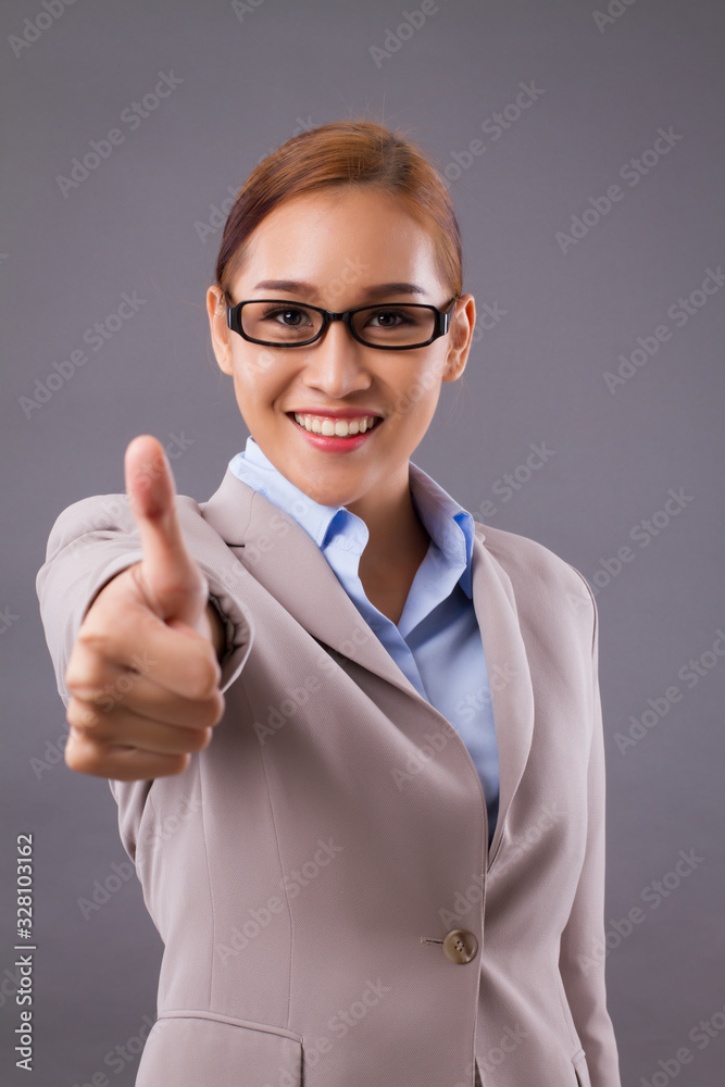 happy smiling business woman pointing thumb up gesture; concept of good deal, fine business, yes answer, deal maker, acceptance, approval happy smiling business woman pointing thumb up gesture; concept of good deal, fine business, yes answer, deal maker, acceptance, approval