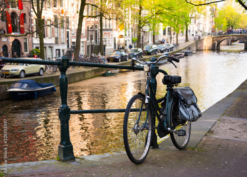 Amsterdam city in Netherlands with bycicles beside a canal