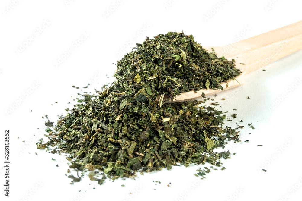 dried nettle herb or in latin Utricae folium in wooden spoon isolated on white background. medicinal healing herbs. herbal medicine. alternative medicine dried nettle herb or in latin Utricae folium in wooden spoon isolated on white background. medicinal healing herbs. herbal medicine. alternative medicine