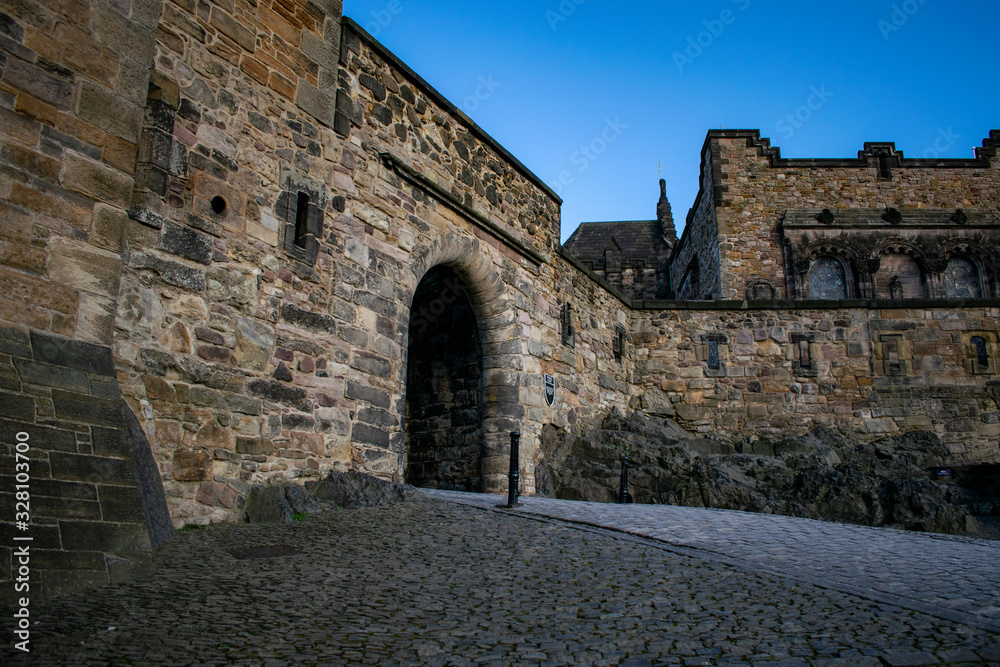 inside the castle in edimburgh city, scotland on the rocks with a blue sky at sunset