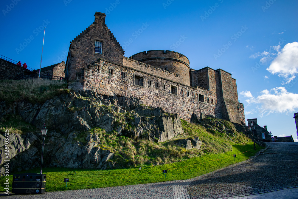 inside the castle in edimburgh city, scotland on the rocks with a blue sky at sunset
