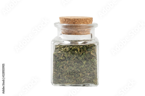 dried nettle herb or in latin Utricae folium in a glass jar isolated on white background. medicinal healing herbs. herbal medicine. alternative medicine photo