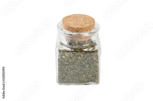 dried nettle herb or in latin Utricae folium in a glass jar isolated on white background. medicinal healing herbs. herbal medicine. alternative medicine