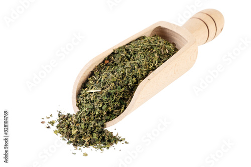 dried nettle herb or in latin Utricae folium in wooden scoop isolated on white background. medicinal healing herbs. herbal medicine. alternative medicine