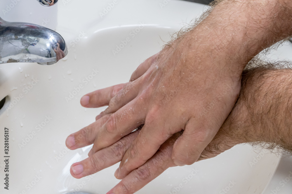 Fototapeta premium Man washing hands in basin close-up