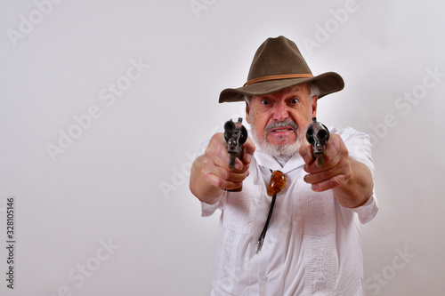 Angry old man aims two revolvers at you..Elderly gentleman with floppy hat and two revolvers.Senior man looking mean, aiming his pistols right at you.You're fired!.