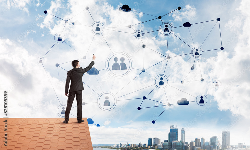 Businessman on house roof presenting networking and connection concept. Mixed media Businessman on house roof presenting networking and connection concept. Mixed media