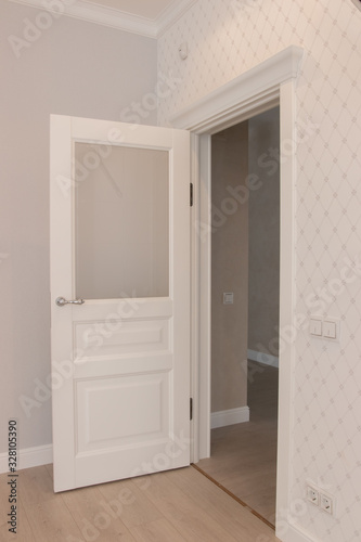  Modern white door. Gray wall with free space. Minimalist bright interior