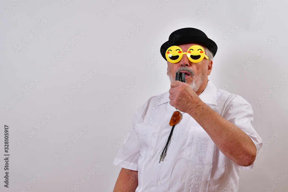 Old man singing at a party wearing funny glasses.Elderly gentleman ...