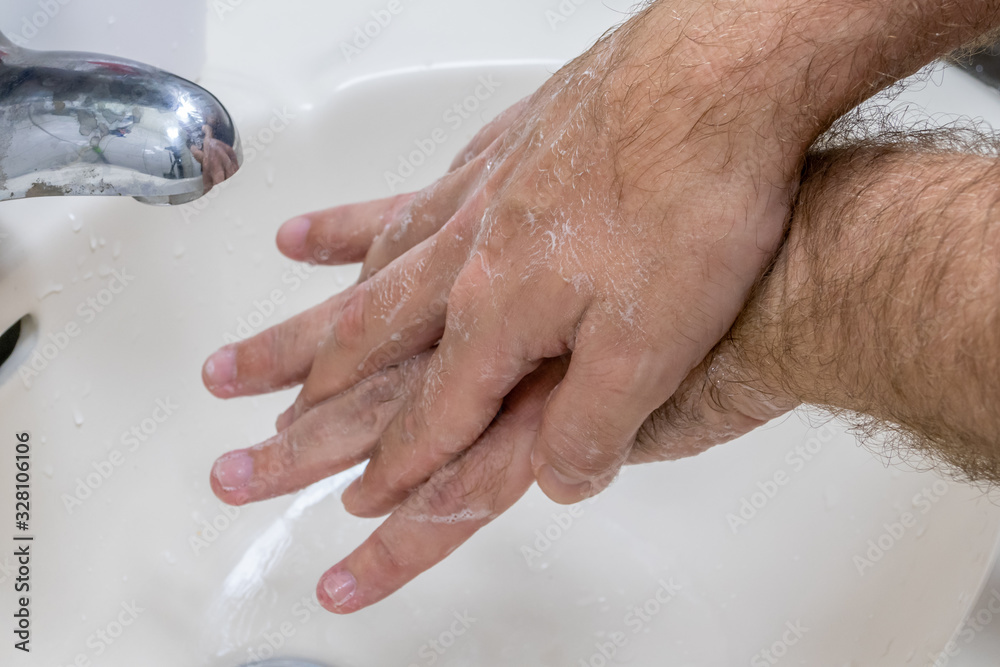 Man washing hands in basin close-up