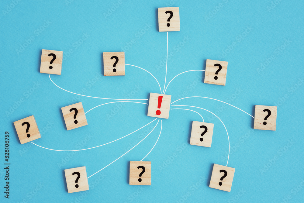 Fototapeta premium Leadership and solution task concept. Wooden blocks with question marks connected to exclamation mark on a blue background