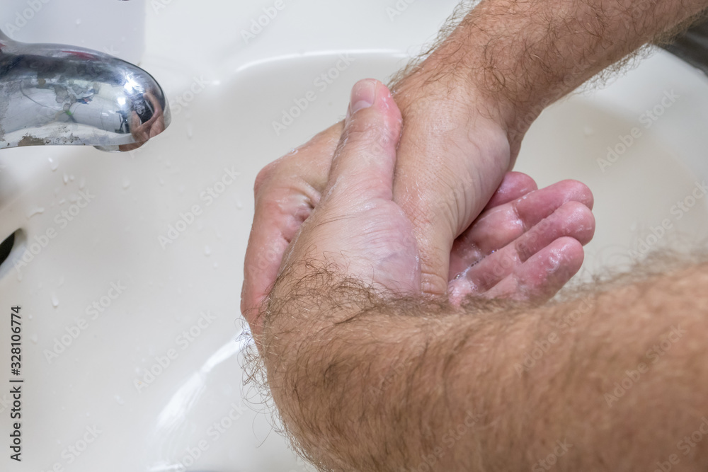 Fototapeta premium Man washing hands in basin close-up